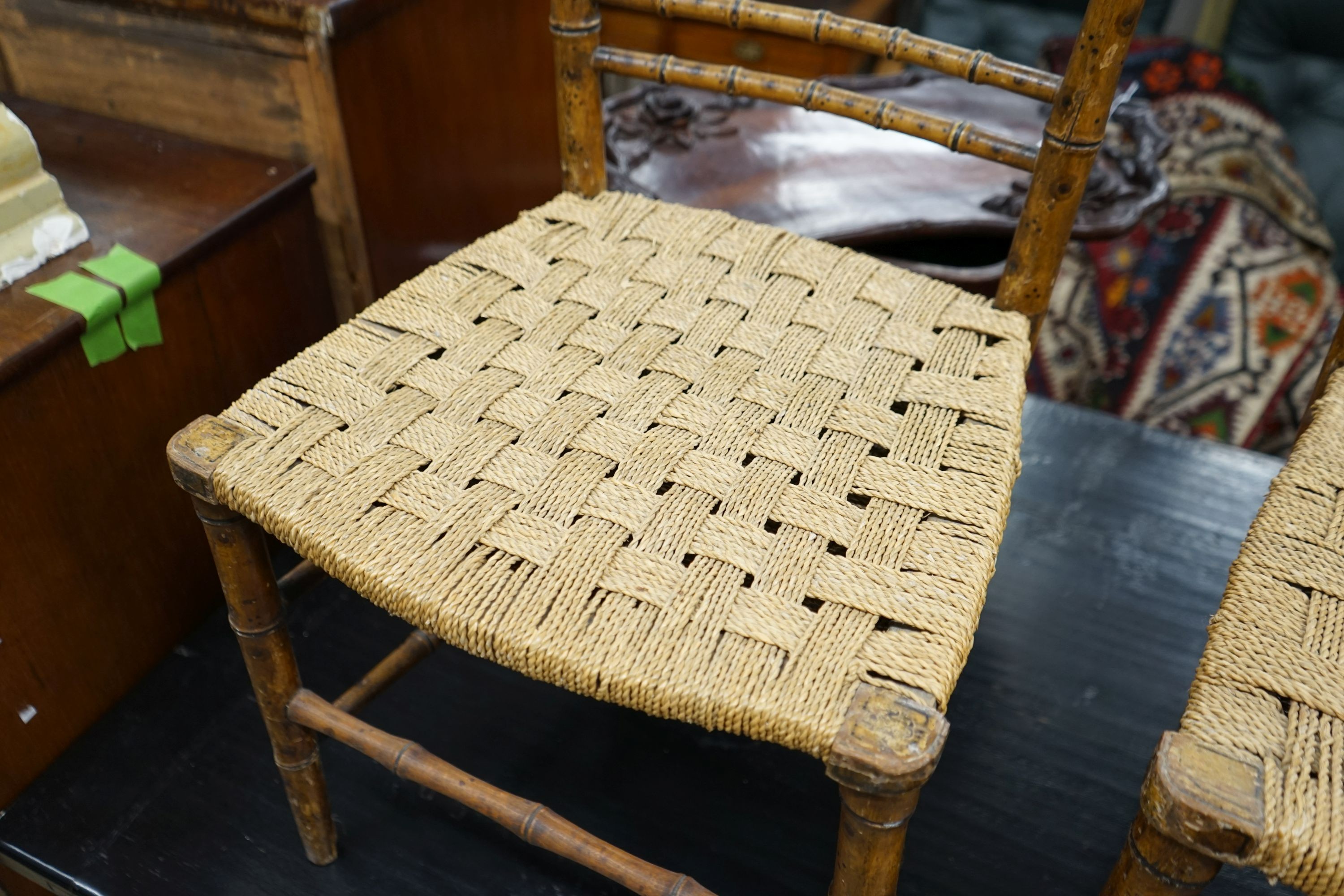 A pair of Regency faux bamboo cane seated chairs